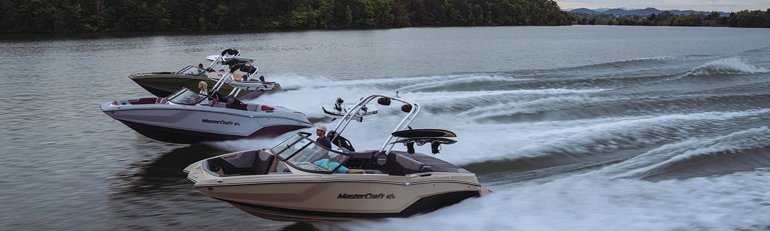 Three MasterCraft boats speeding across Lake Washington