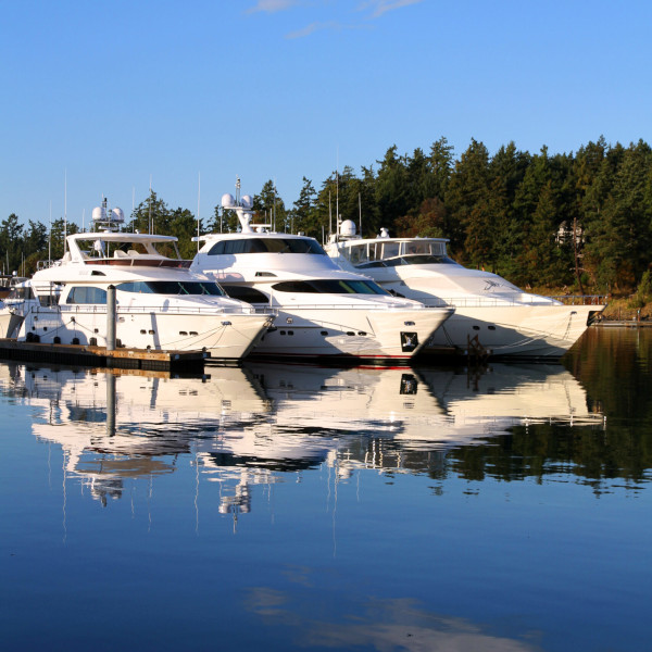 Three docked yachts at sunset